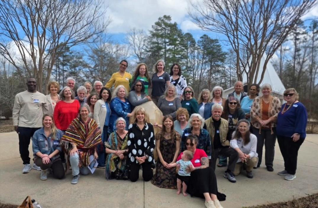 Group of spiritual studies students and faculty gathered outdoors during a psychic school training event.
