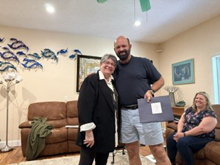 Student receiving recognition during a spiritual studies certification program.